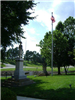 Statue and American Flag on a Lawn