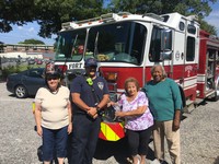 Seniors pose by firetruck